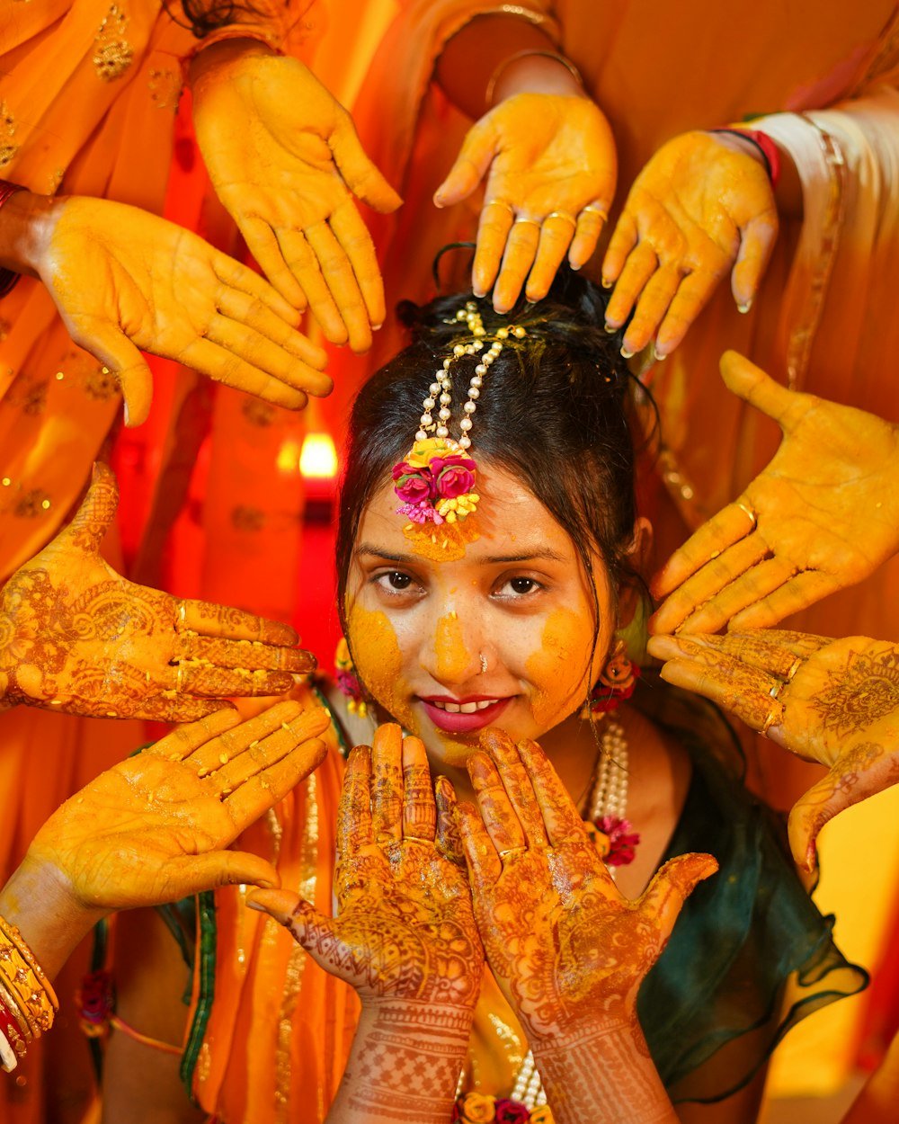 Family gathered around a bride during her haldi ceremony